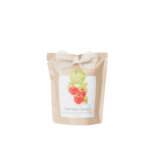 Un Grow Bag personnalisable de bougie tomate avec un noeud dessus.